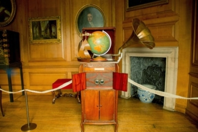 Photograph of an old music player with a globe on top of it.